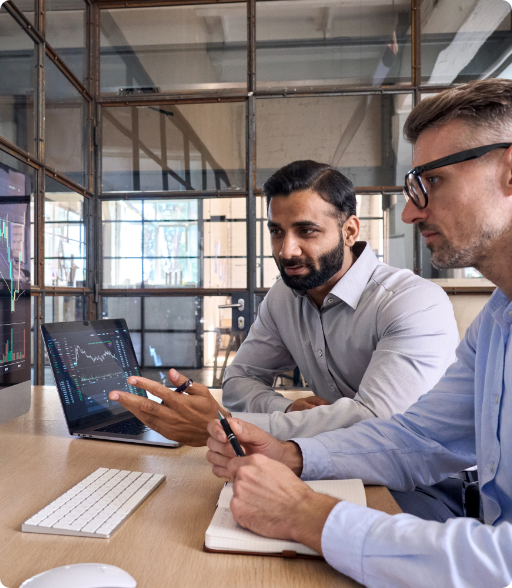 two men working on computers together